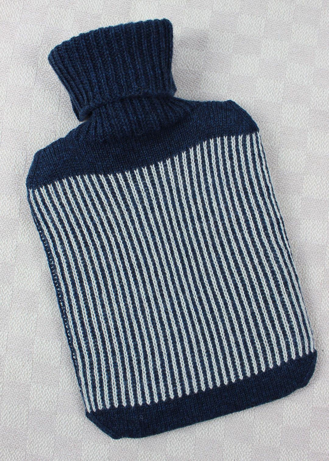 Striped hot water bottle cover in ocean blue.