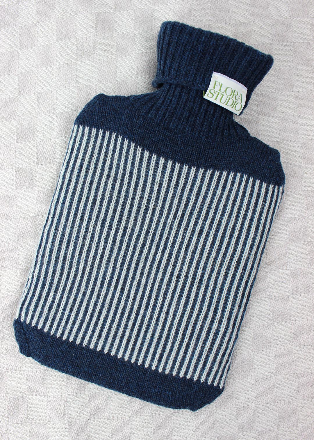 Striped hot water bottle cover in ocean blue.