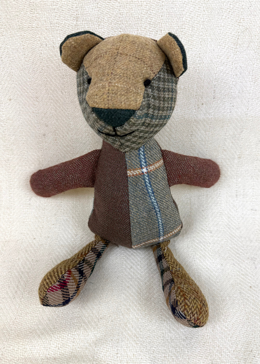Tweed patchwork bear in browns, greens and oranges. Scottish Textiles Showcase.