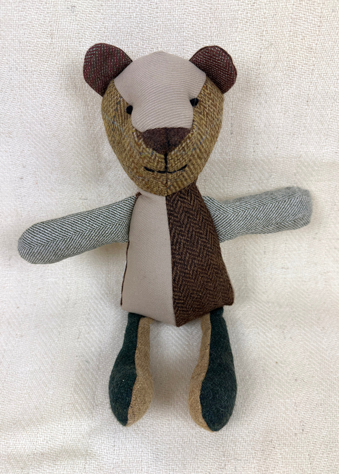 Tweed patchwork bear in browns, greens and oranges. Scottish Textiles Showcase.