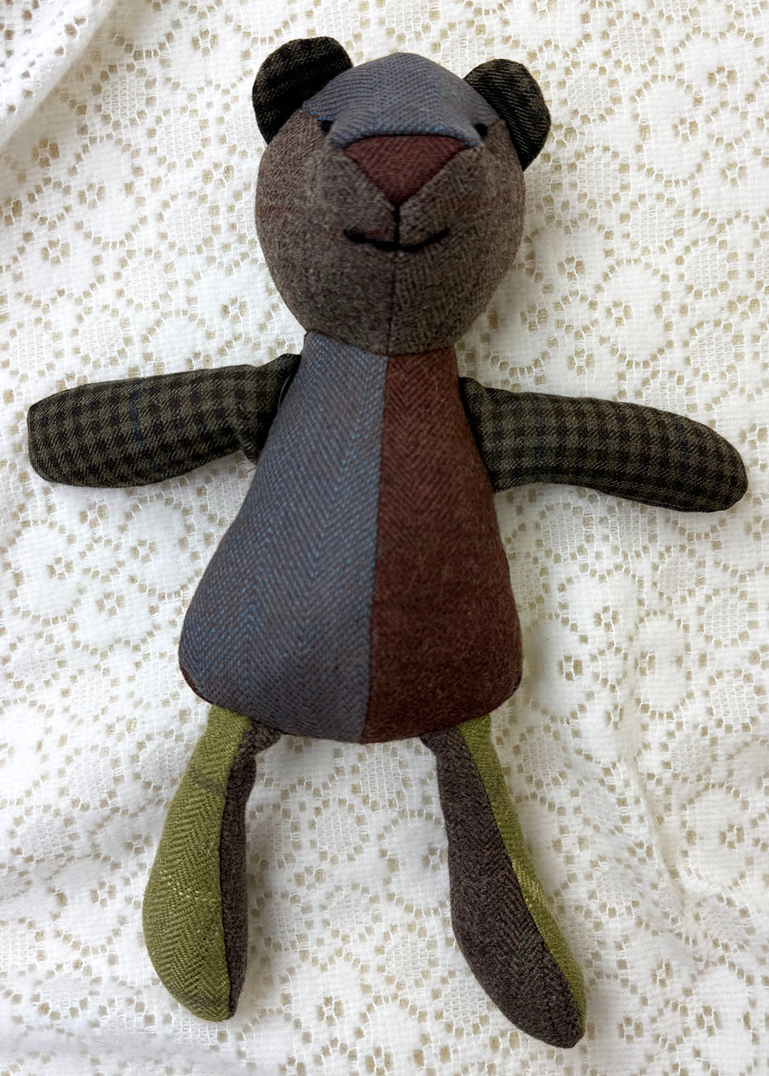 Tweed patchwork bear in browns, greens and oranges. Scottish Textiles Showcase.