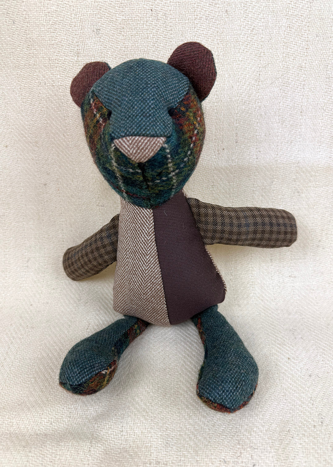 Tweed patchwork bear in browns, greens and oranges. Scottish Textiles Showcase.