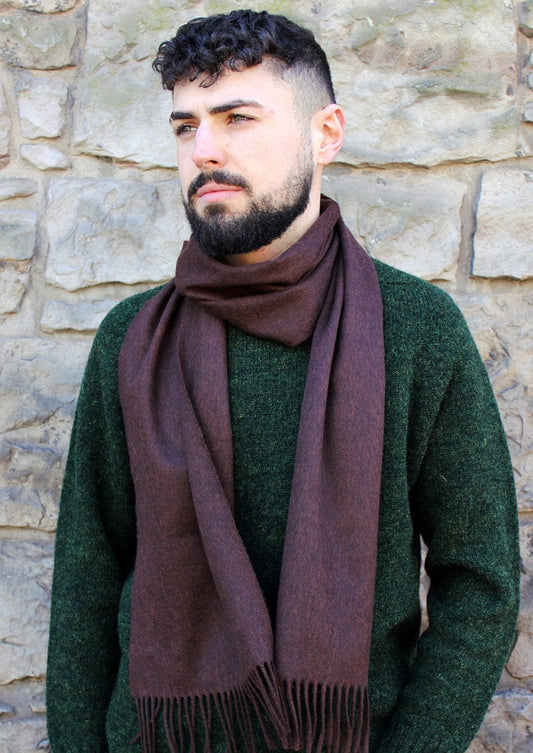 Brown peaty cashmere scarf shown on model. Scottish Textiles Showcase.