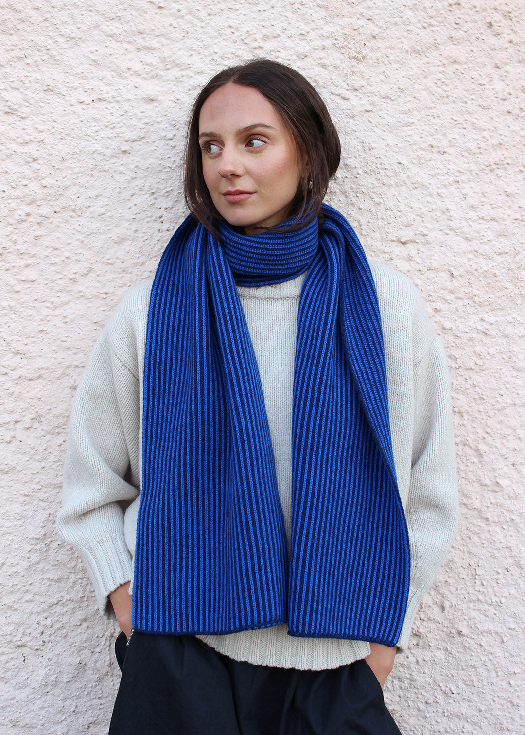 Lambswool cobalt blue and navy striped scarf shown on model. Scottish Textiles Showcase.