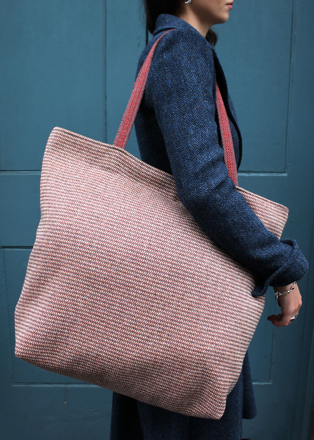 Wool travel bag shown on model. Scottish Textiles Showcase.