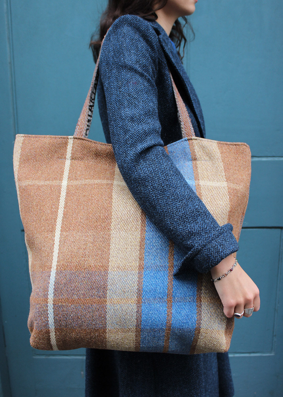 Wool travel bag shown on model. Scottish Textiles Showcase.