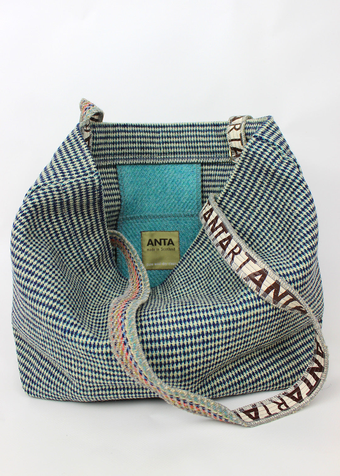 Wool carpet bag woven in teal blue and white.