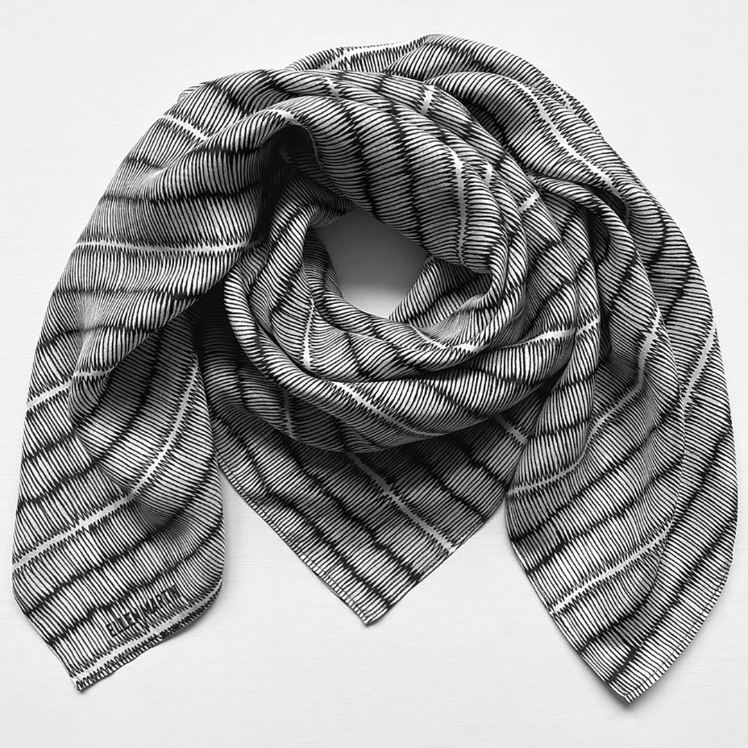 Large silk square scarf with black and white repeat pattern.