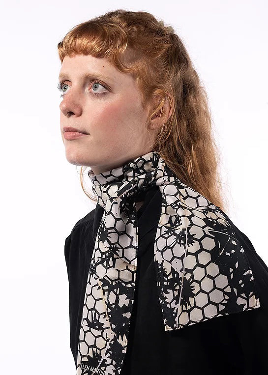 The Mono skinny silk scarf has been digitally printed with a repeat pattern in off-white and navy-black.