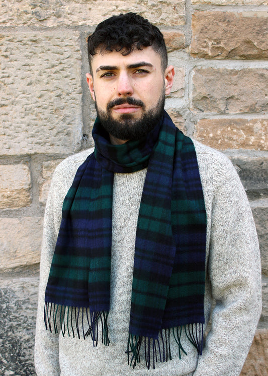 Black watch tartan cashmere scarf shown on model. Scottish Textiles Showcase.