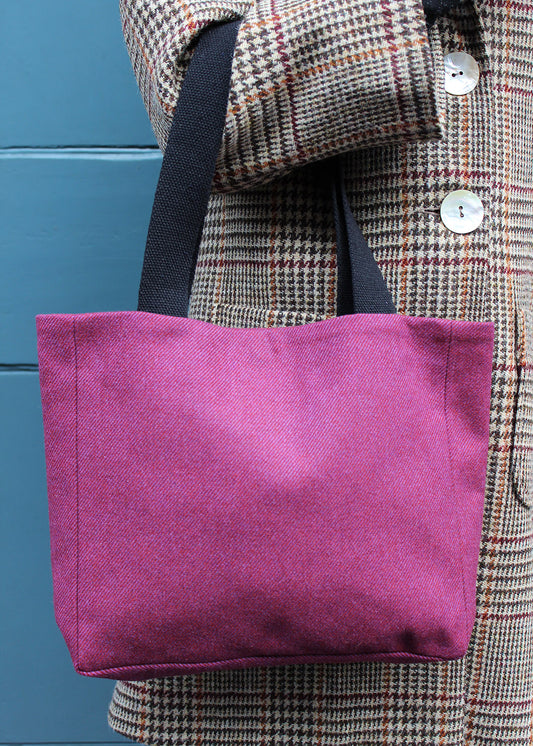 Stylish and sustainably made square tote bag made from a beautiful magenta wool with sturdy black straps.