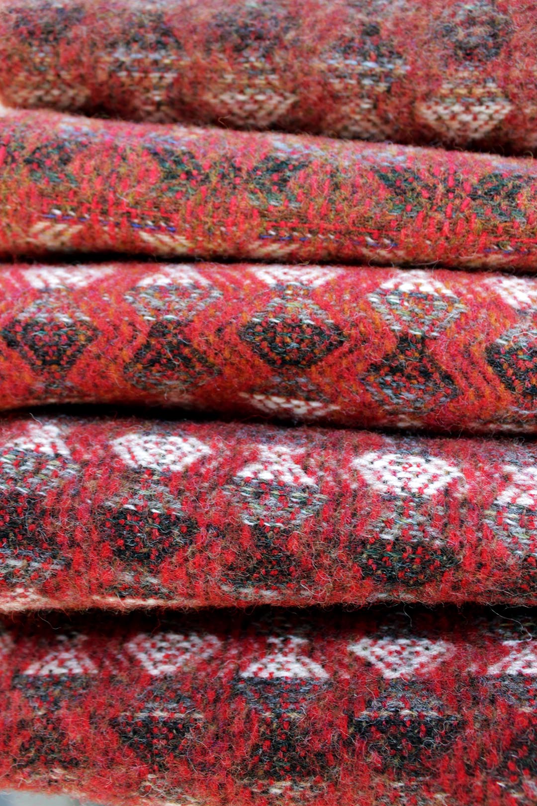 Sustainably woven Scottish wool tapestry throw or blanket in shades of red, Scottish Textiles Showcase
