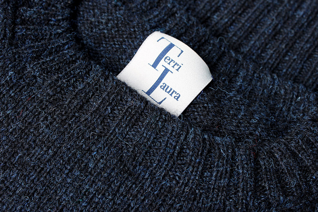 Made from authentic Shetland sheep wool from Jamieson's of Shetland, this beautifully knitted crew neck jumper comes in a black navy marl, giving it a beautiful textured feel. Exclusive to the Scottish Textiles Showcase.