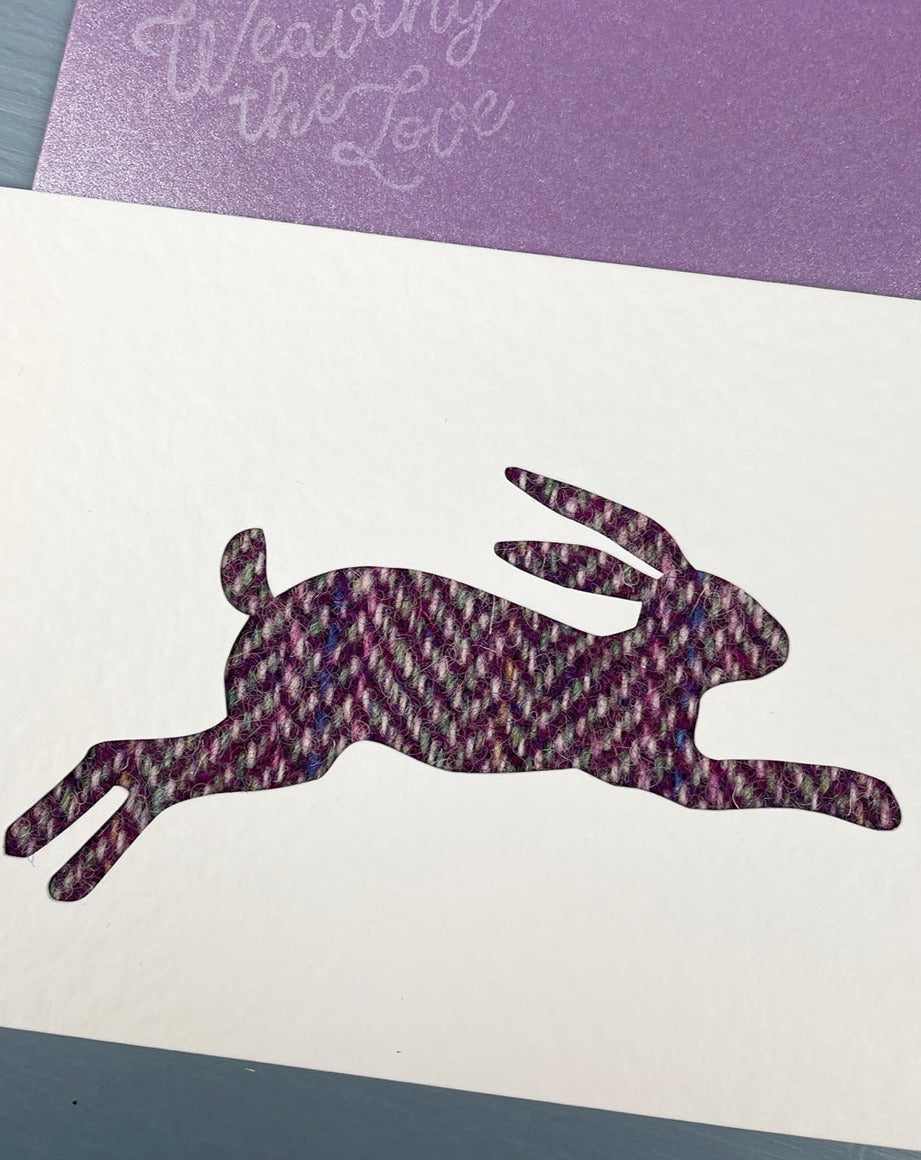 Handmade greetings card by Weaving the Love featuring leaping mountain hare in purple Harris Tweed.