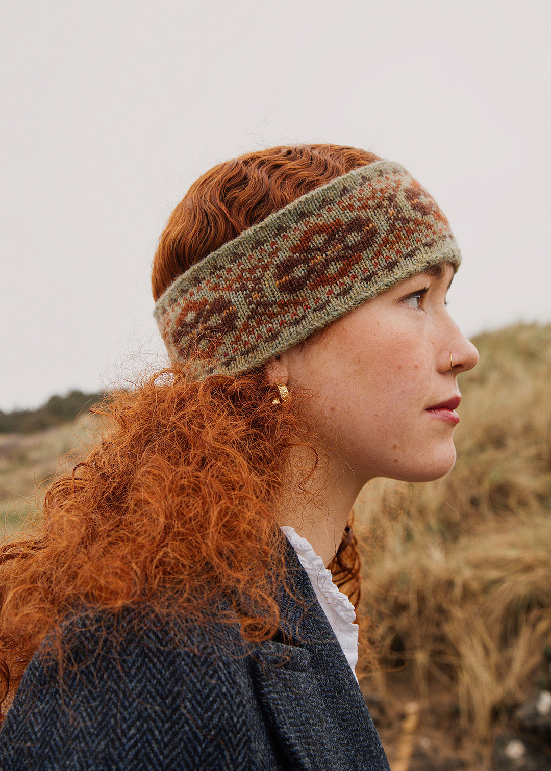 Knitted Shetland Fair Isle headband in earthy tones.