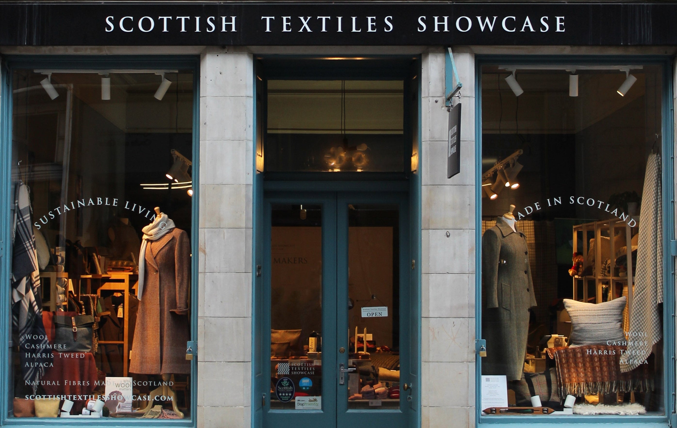 Scottish Textiles Showcase store front with glass windows displaying clothing and decor.