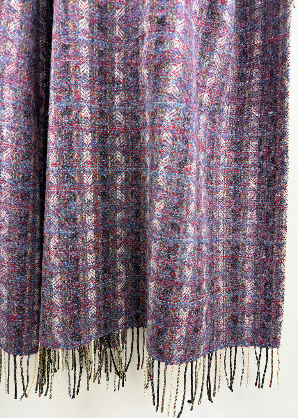 Pure wool tapestry throw in hues of purple and lilac.