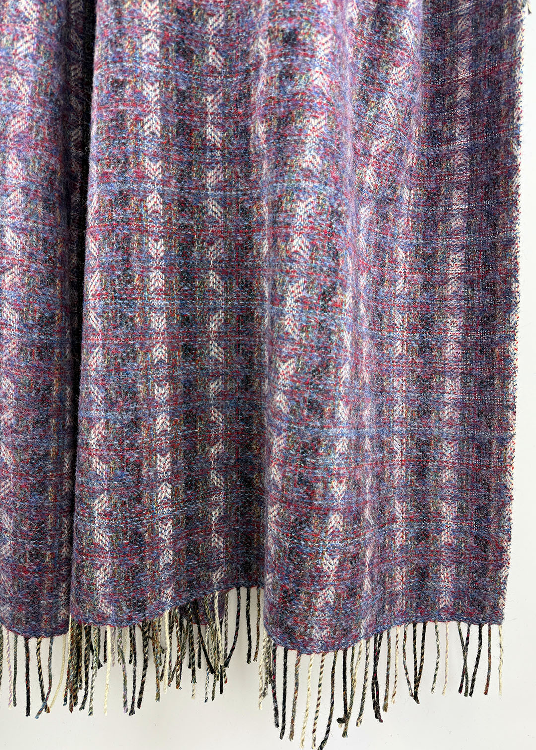 Pure wool tapestry throw in hues of purple and lilac.