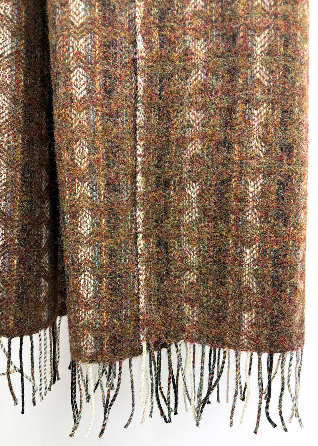 Pure wool tapestry throw in hues of brown and burnt orange.
