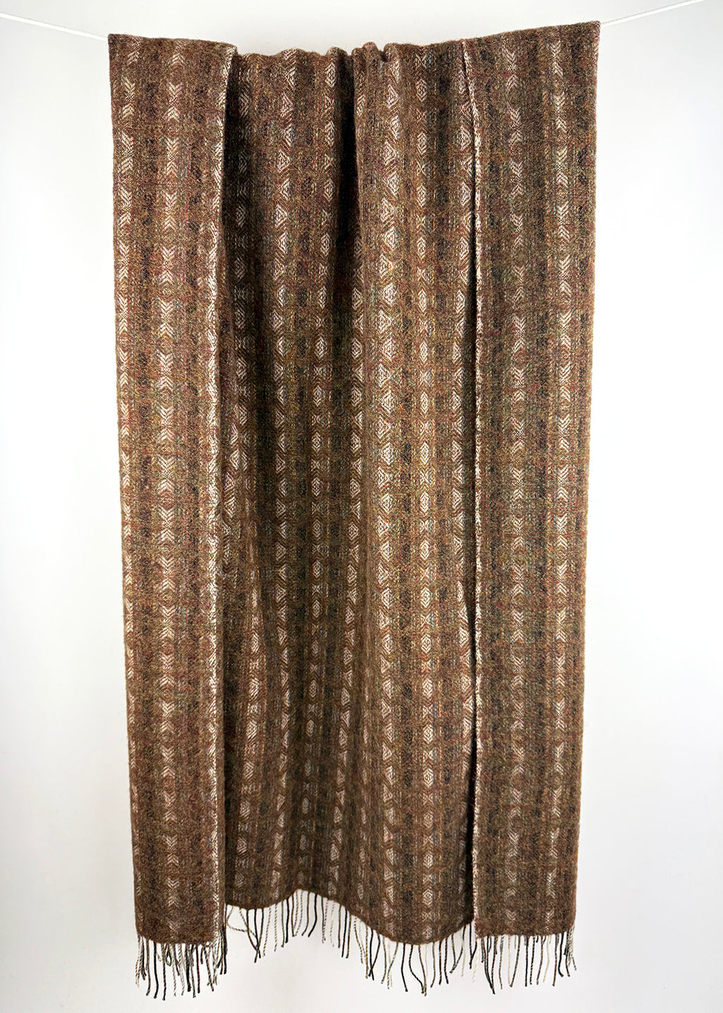 Pure wool tapestry throw in hues of brown and burnt orange.