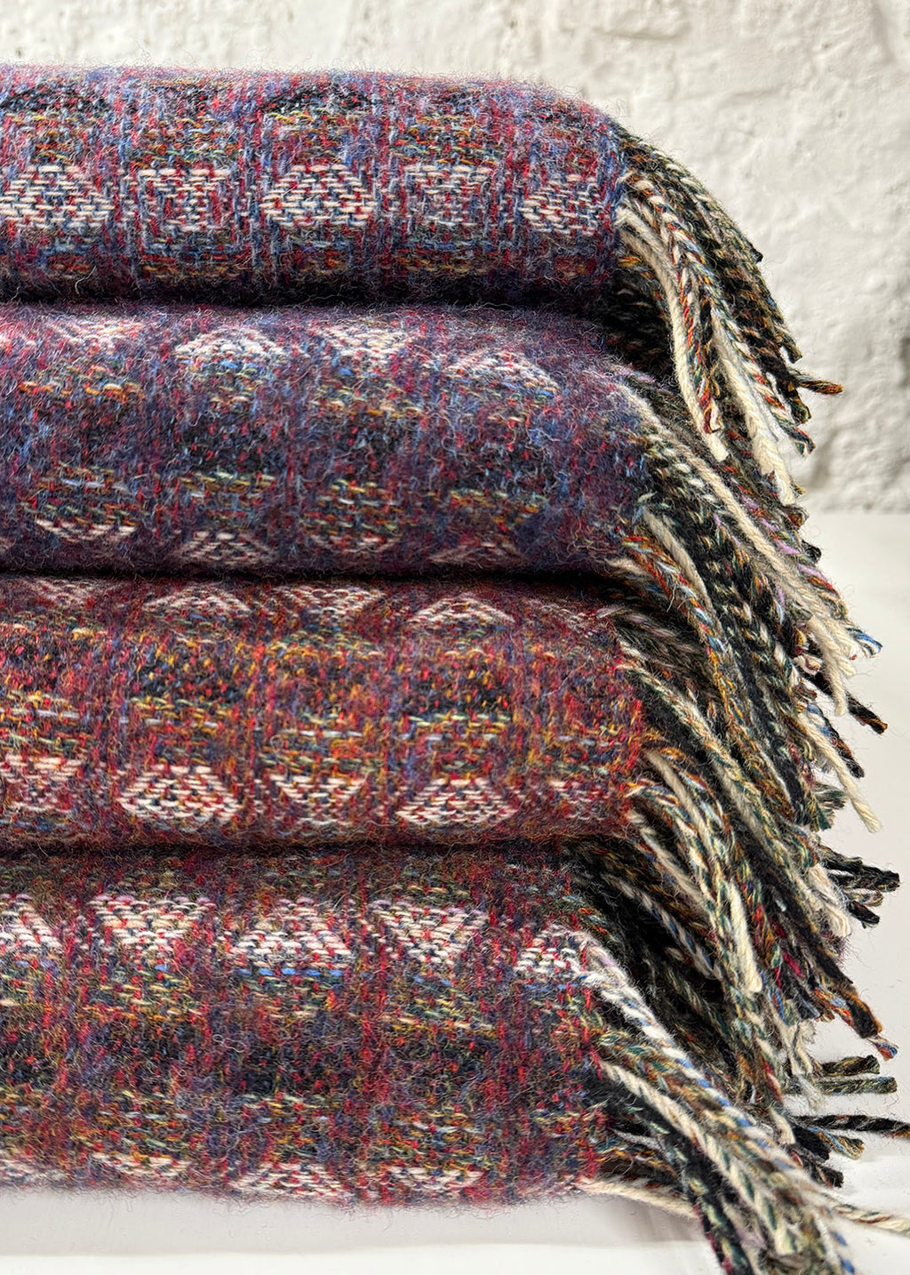 Pure wool tapestry throws in hues of purple and lilac.