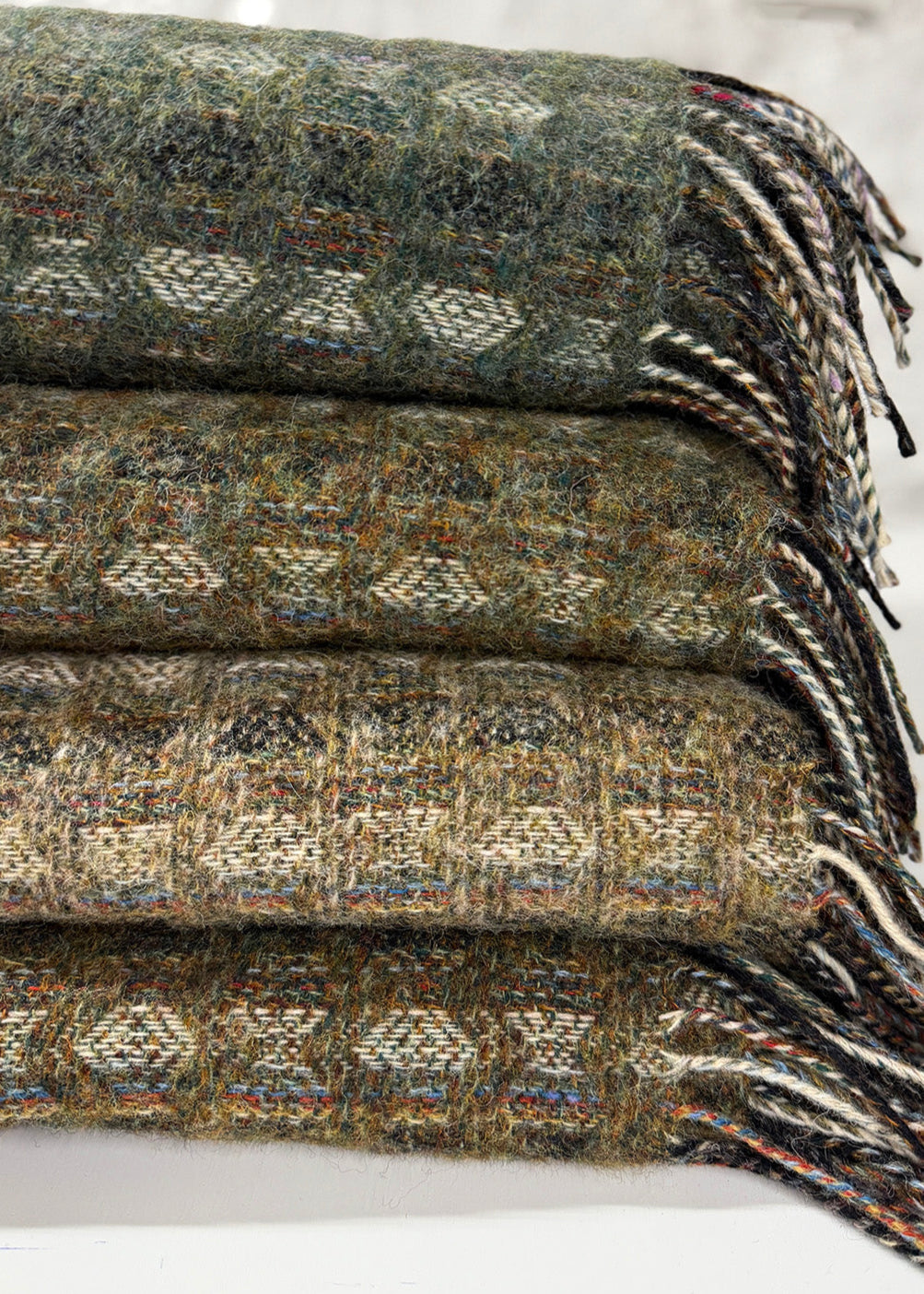 Pure wool tapestry throws in hues of lichen green.