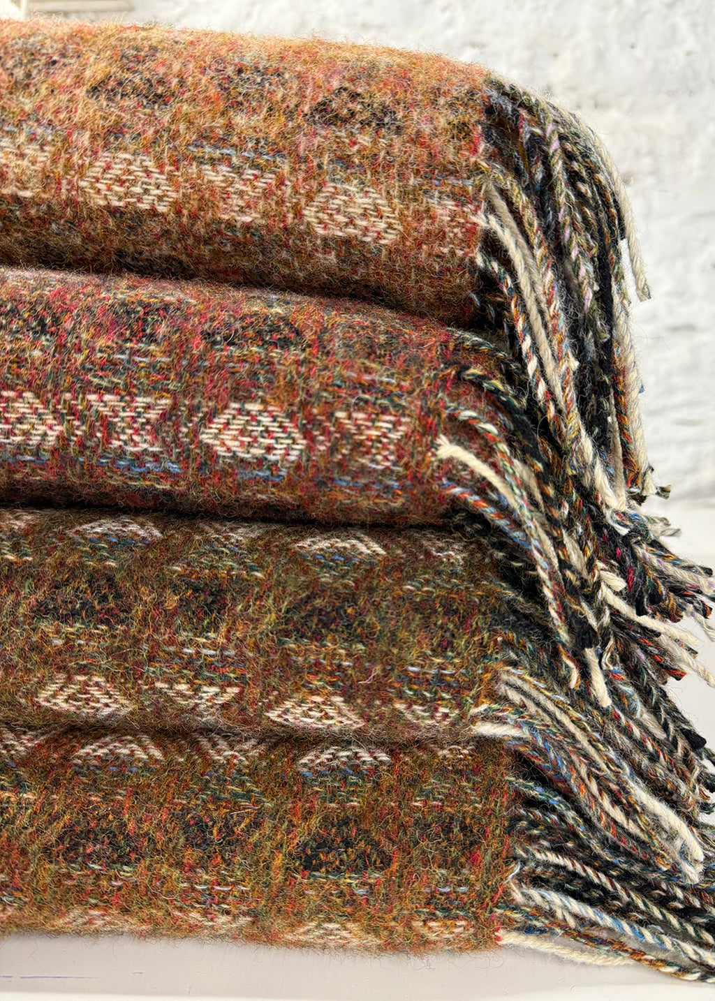 Pure wool tapestry throws in hues of brown and burnt orange.