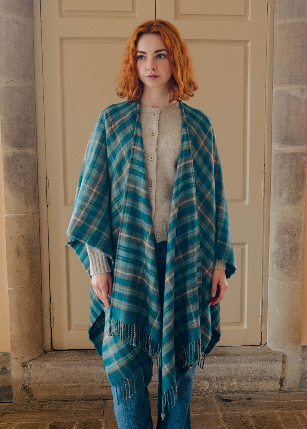 Model wearing a lambswool teal tartan serape.