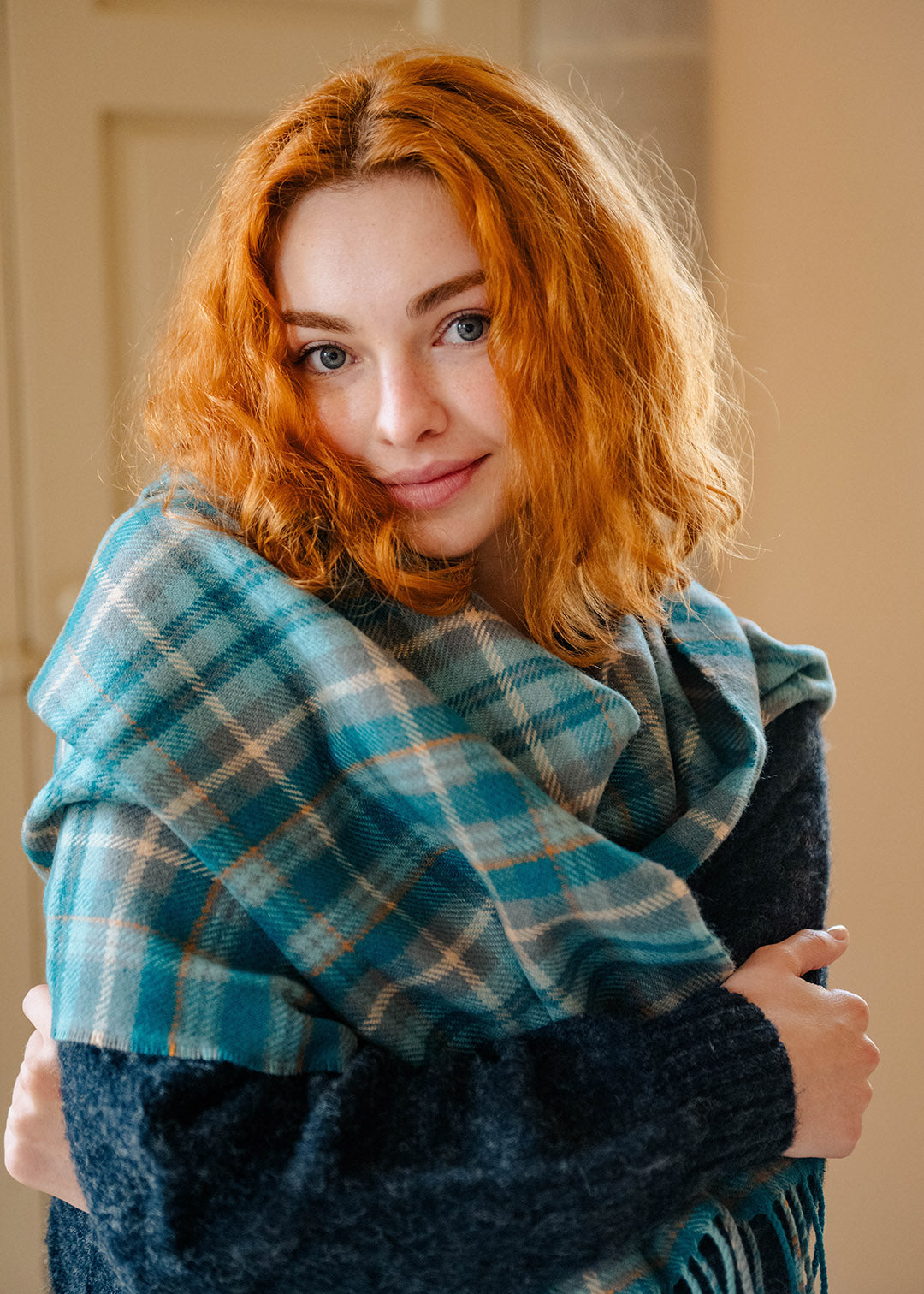 Lambswool teal tartan shawl on model.