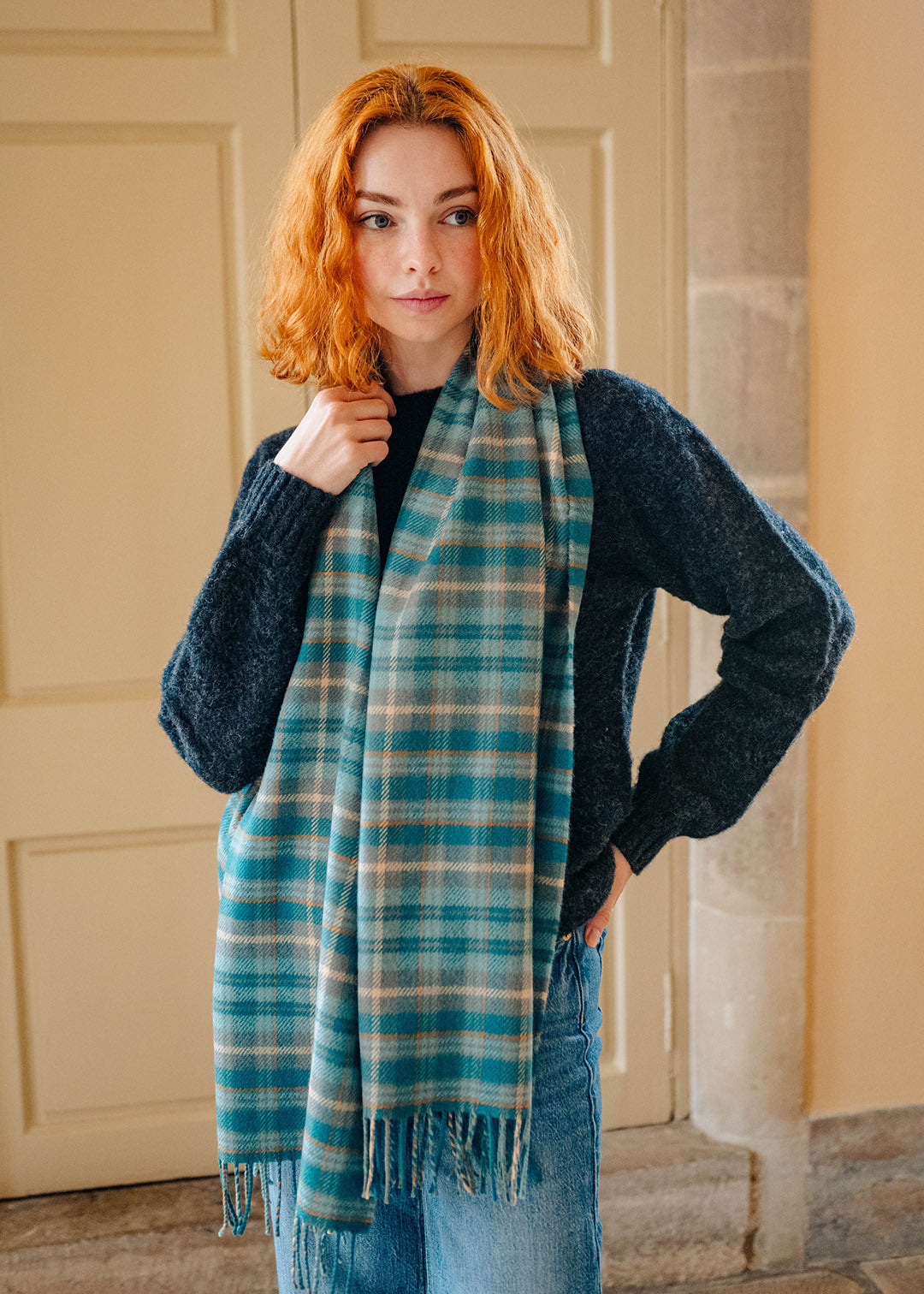 Lambswool teal tartan shawl on model.