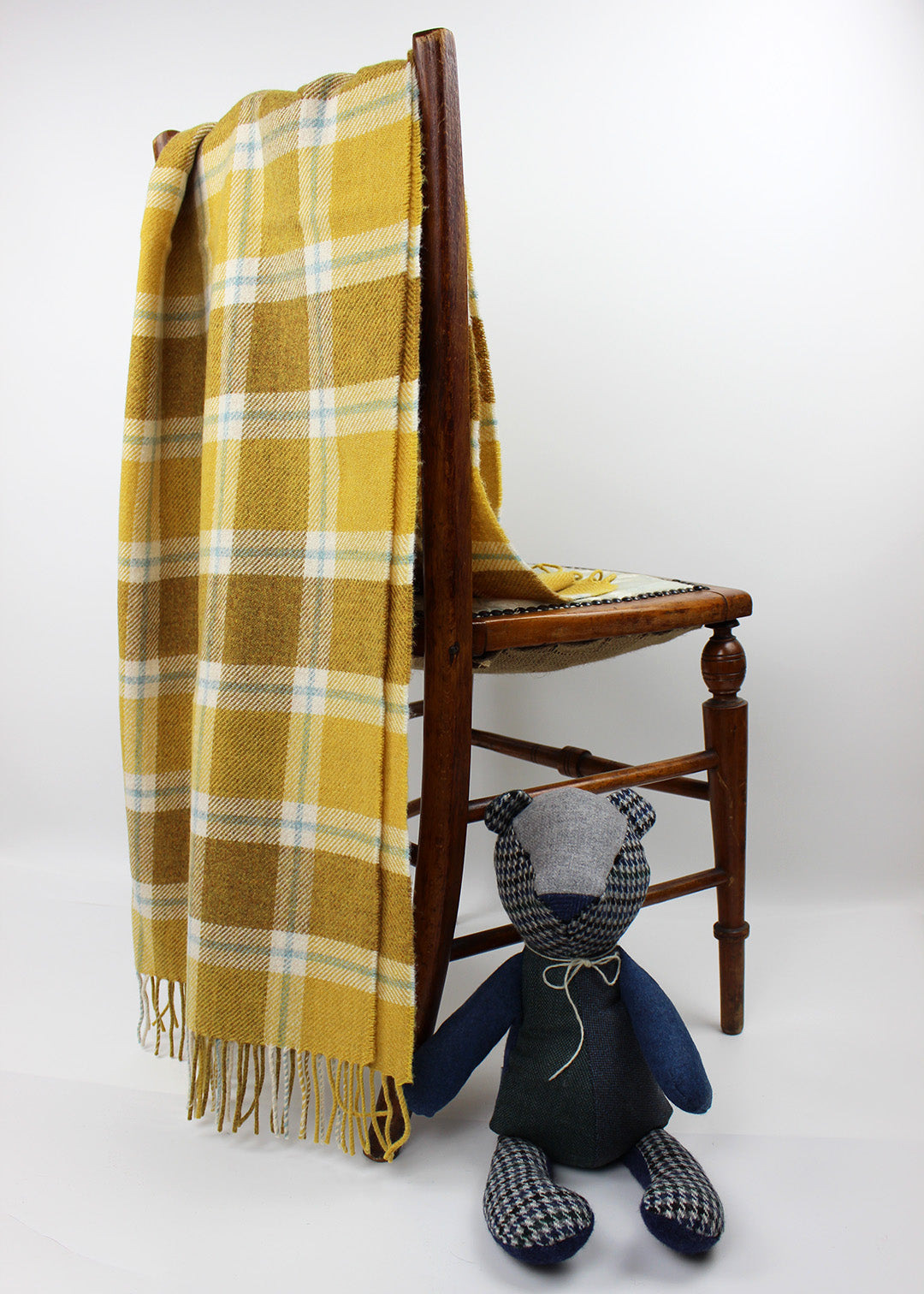 Baby blanket shown photographed with teddy. Scottish Textiles Showcase.