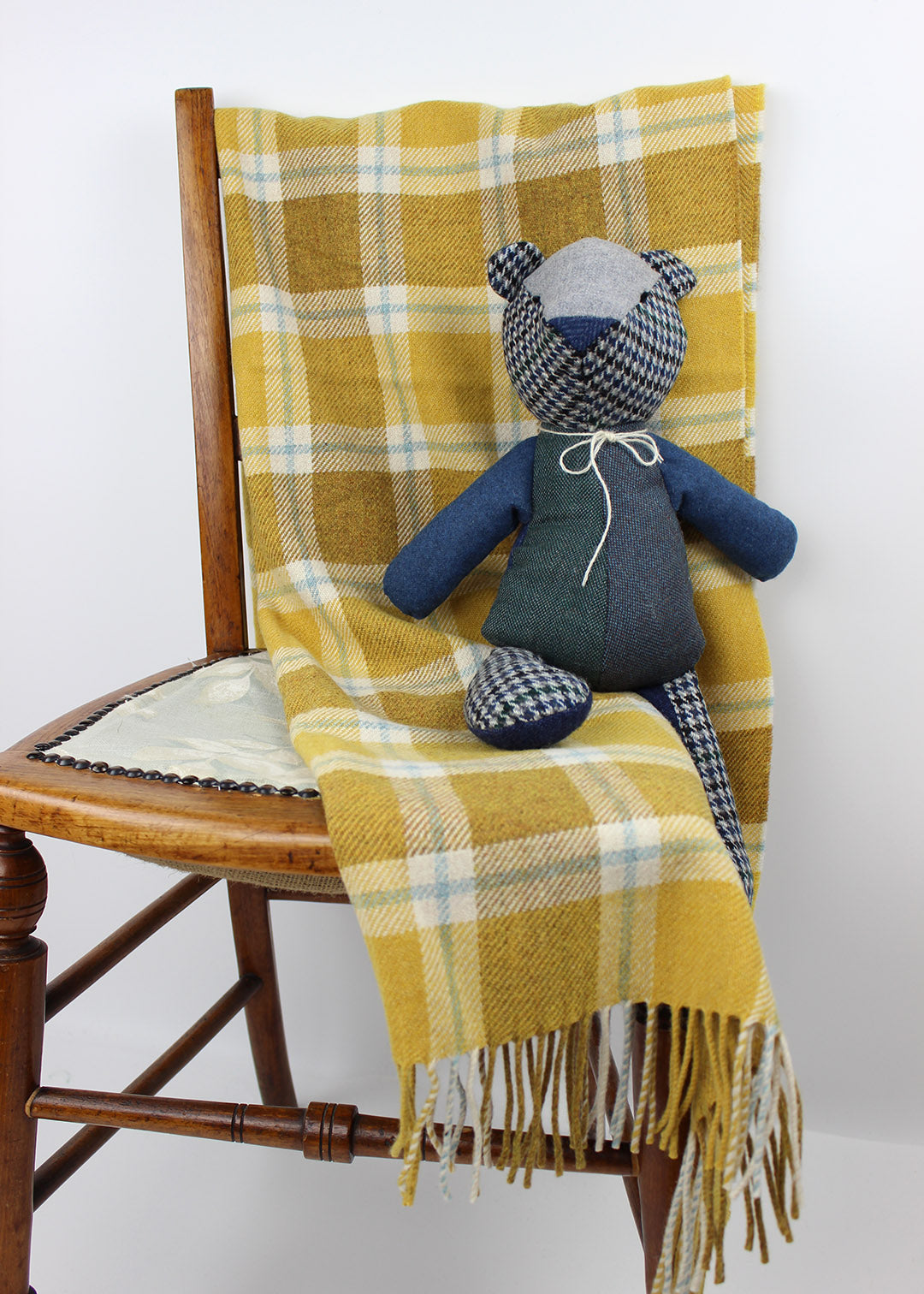 Baby blanket shown photographed with teddy. Scottish Textiles Showcase.
