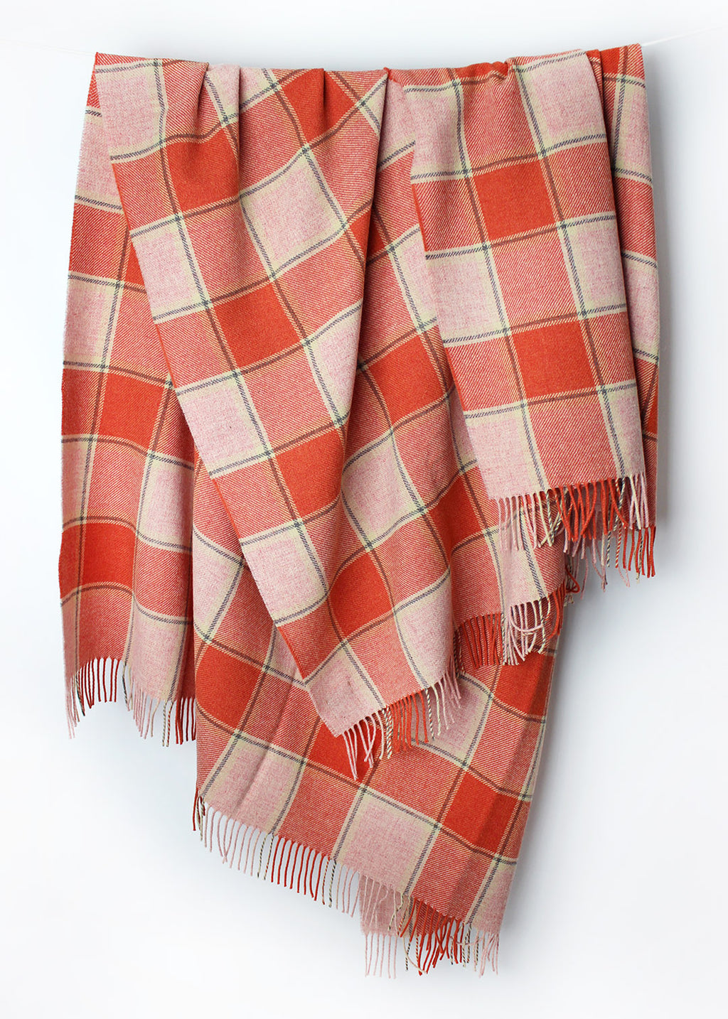 Scottish lambswool throw in coral pink and orange Elizabeth Pirrie colourway.