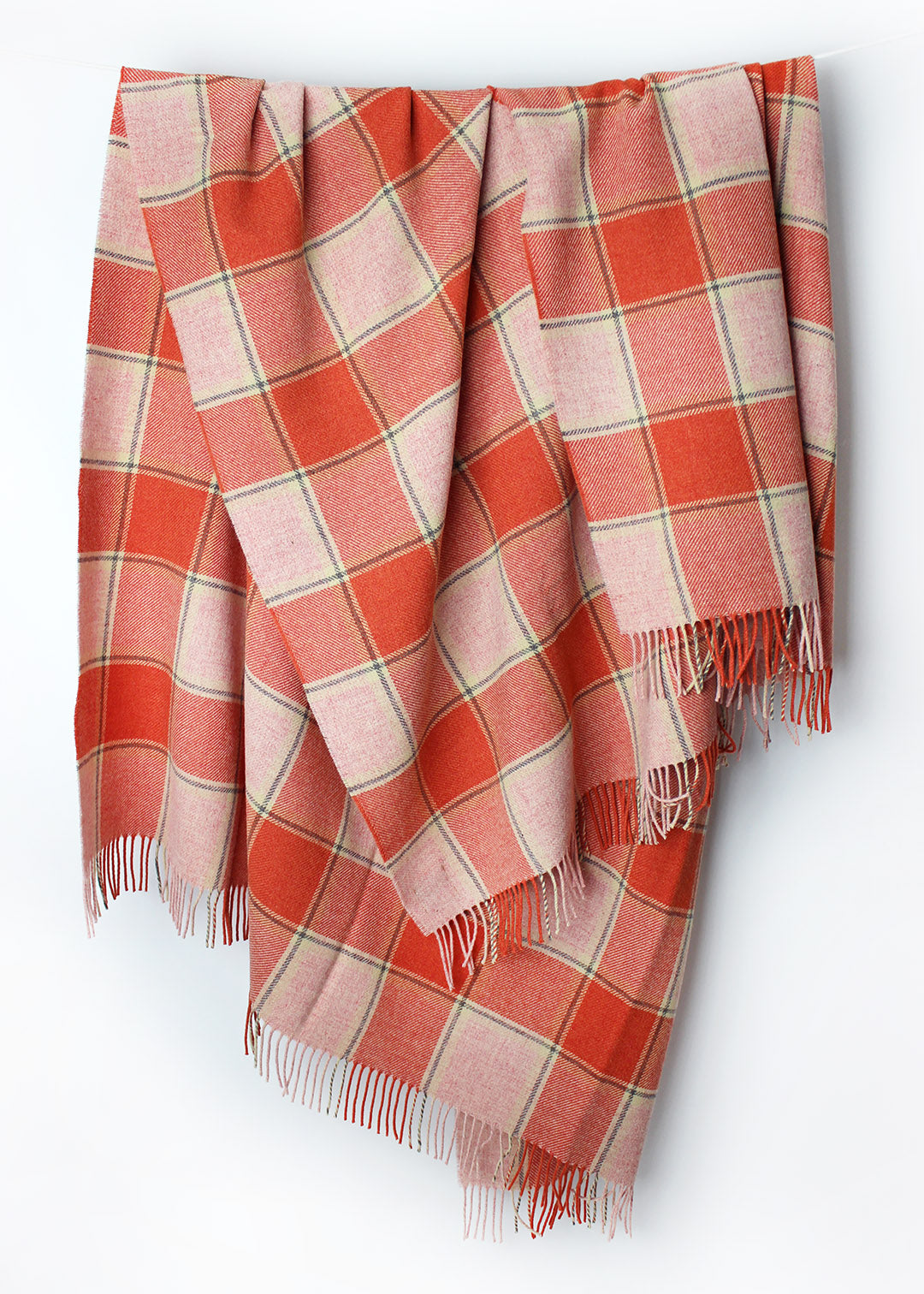 Scottish lambswool throw in coral pink and orange Elizabeth Pirrie colourway.