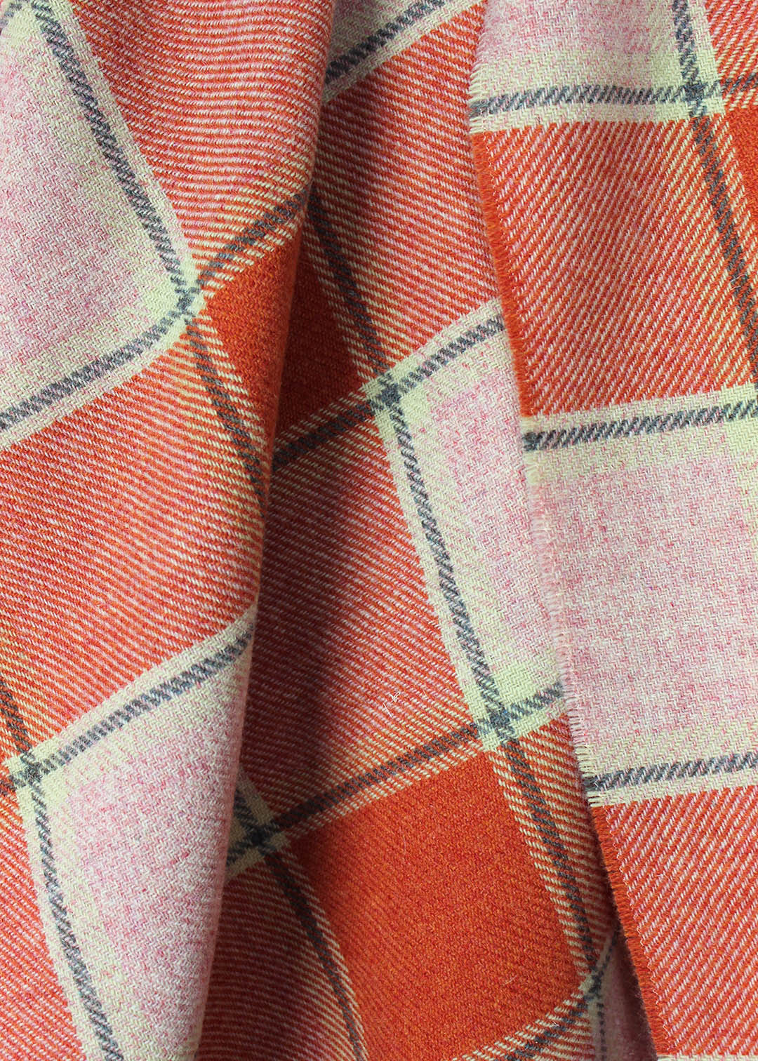 Scottish lambswool throw in coral pink and orange Elizabeth Pirrie colourway.