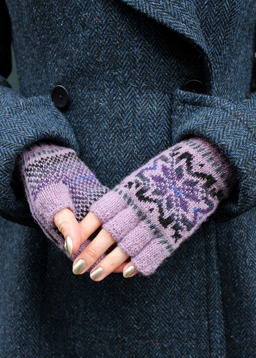 Hand knitted Fair Isle fingerless gloves in lilac with contrasting details.