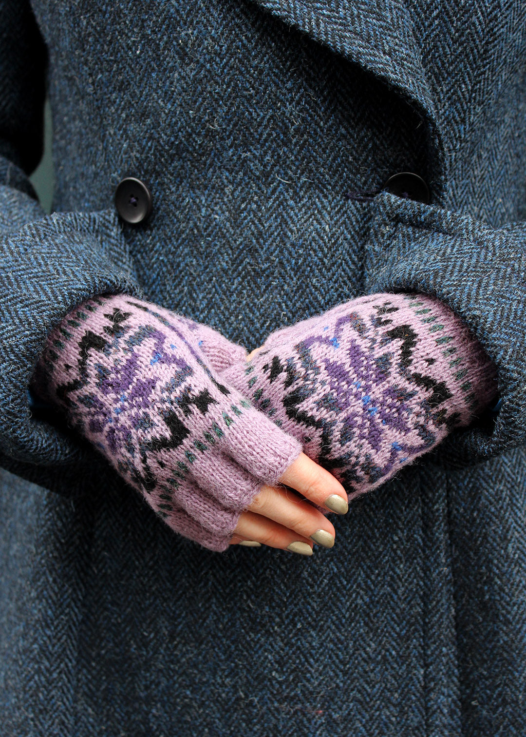 Hand knitted Fair Isle fingerless gloves in lilac with contrasting details.