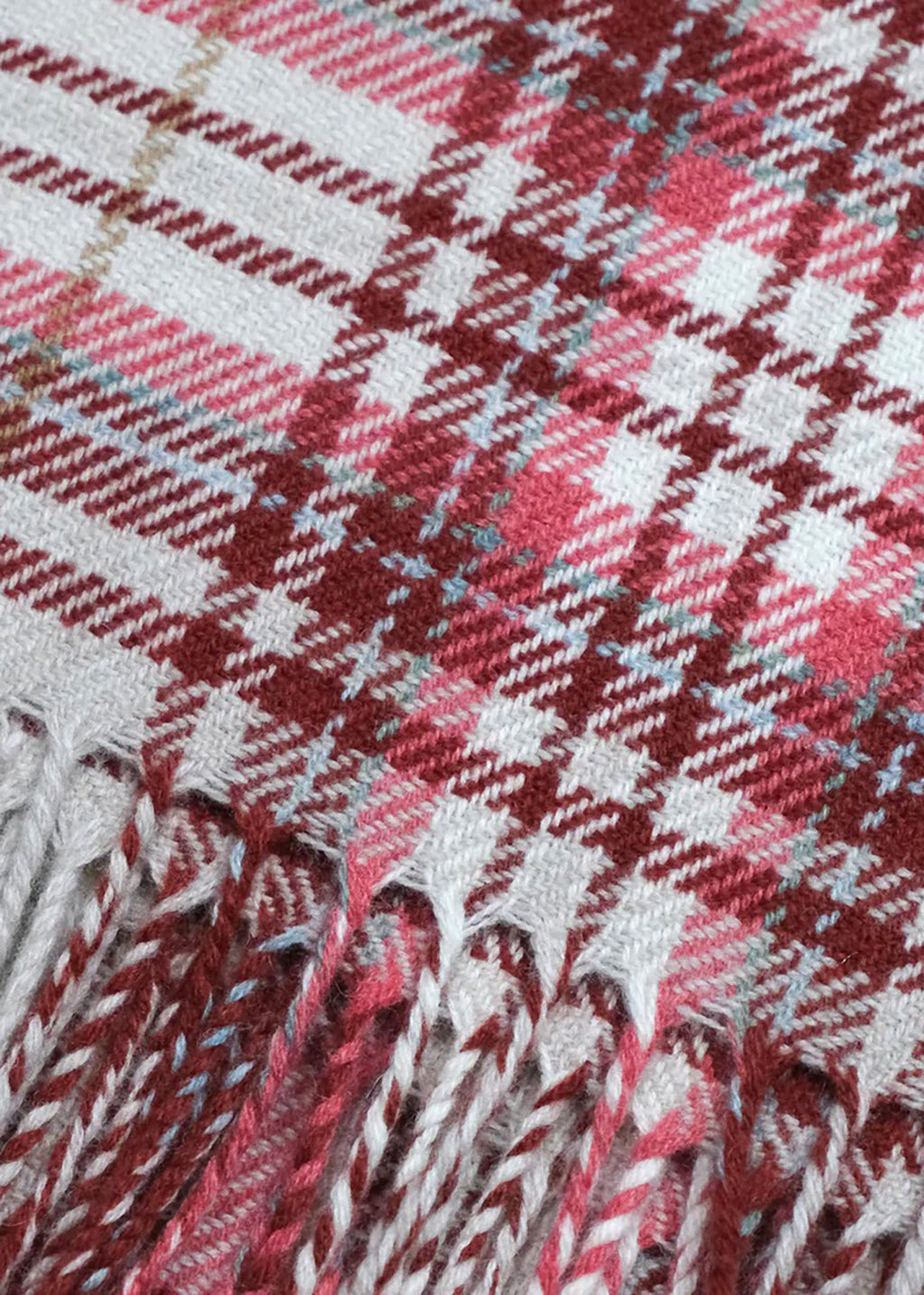 Merino wool baby blanket in red and coral check.