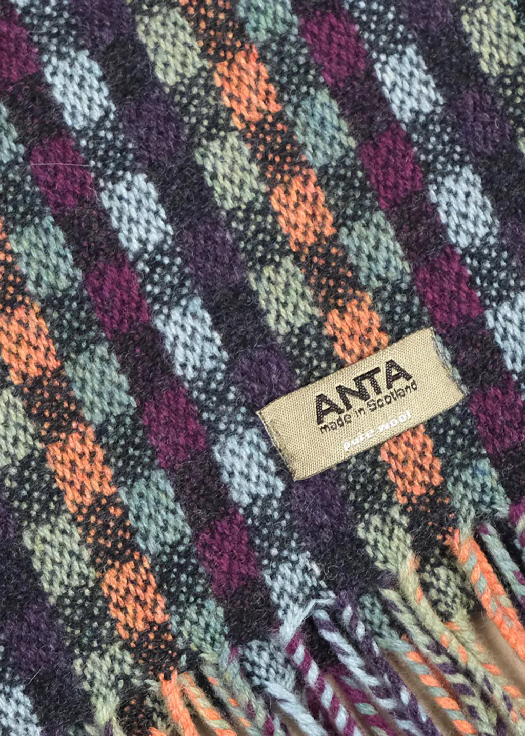 Merino wool baby blanket in check with blue, purple, green and coral.