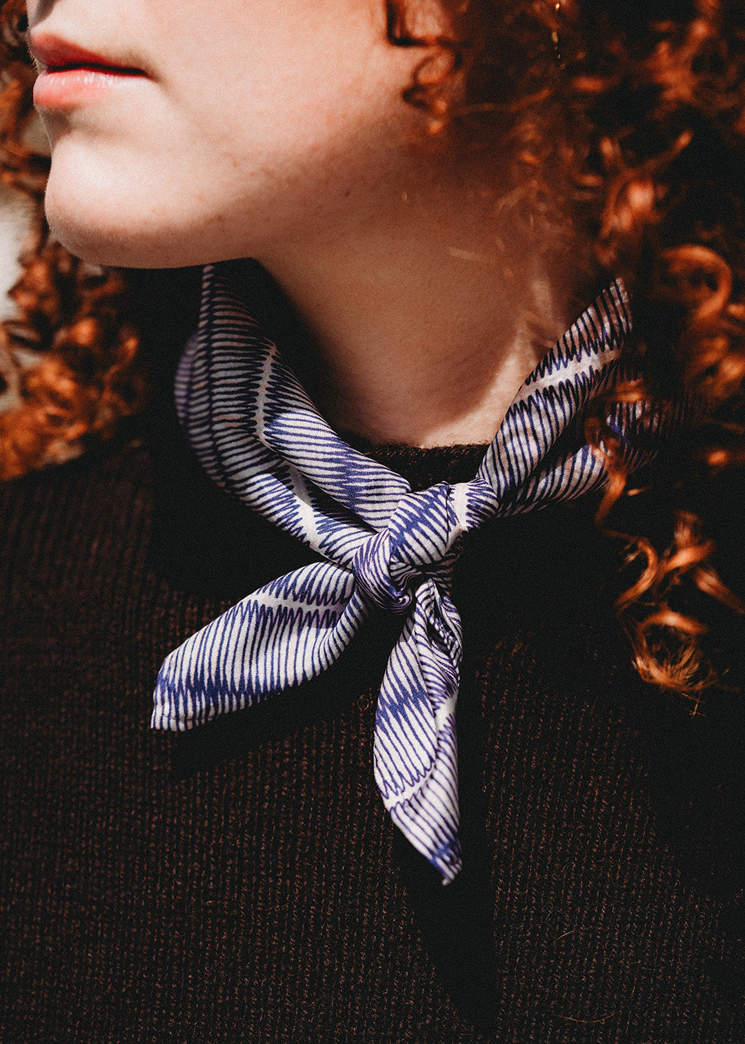 The Tatami small silk scarf has been digitally printed with an intricate repeat pattern in blue and off-white.