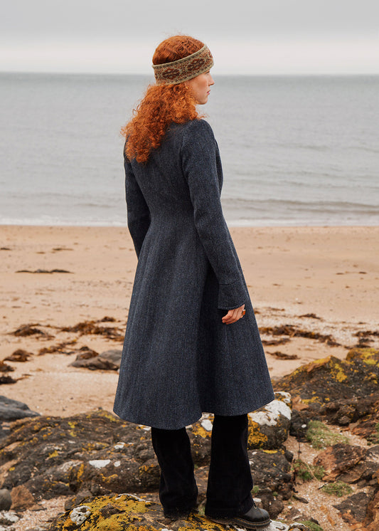 Navy blue and black herringbone Harris Tweed ladies coat shown on model. Scottish Textiles Showcase.