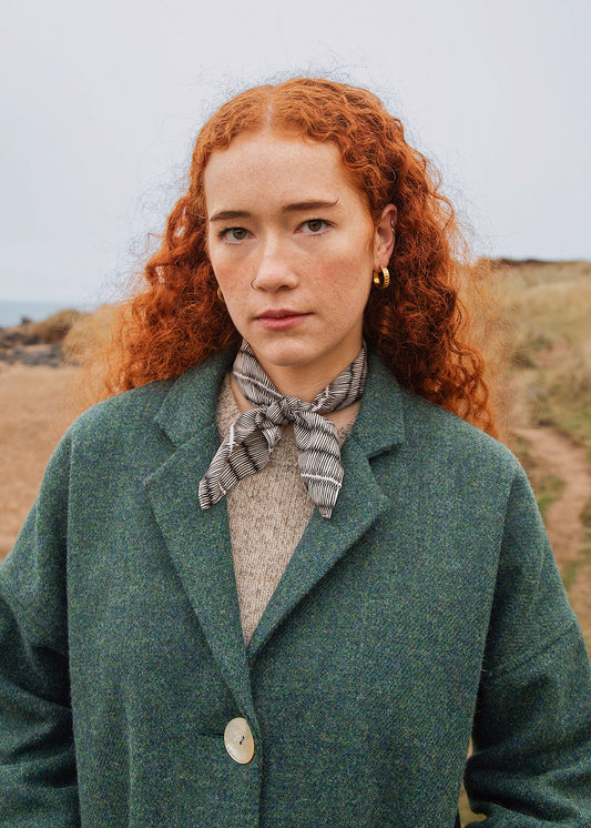The classic Fiona coat in sea blue is made from hand woven Harris Tweed and features a full satin blue lining. Shown on model. Scottish Textiles Showcase.