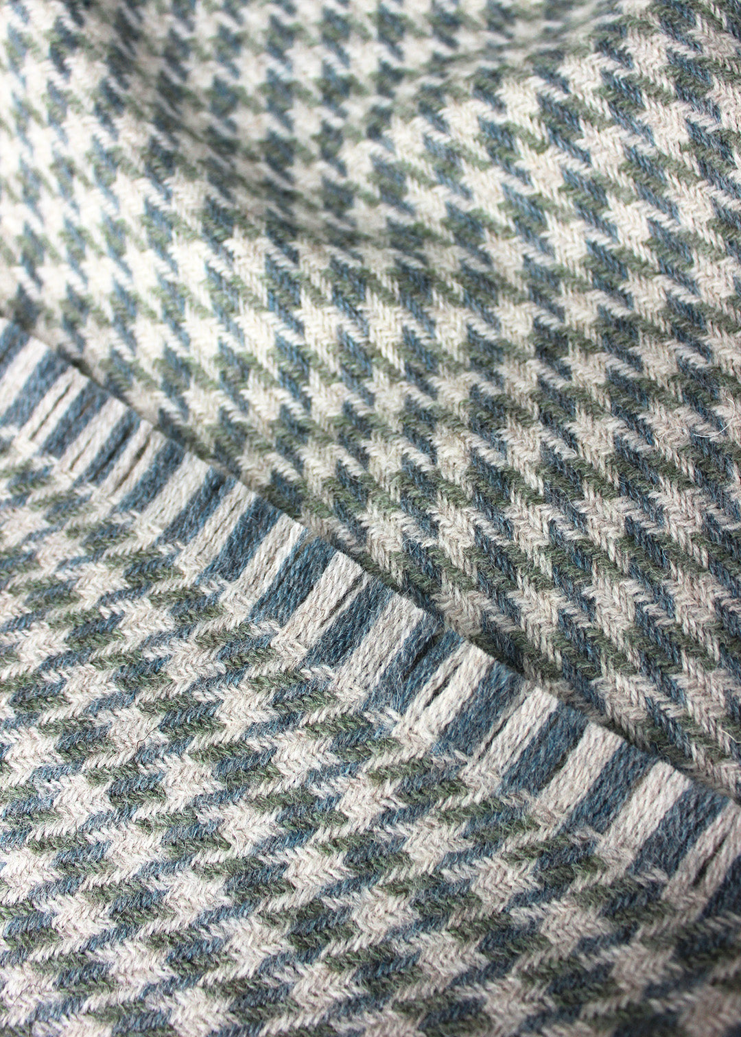 Houndstooth blanket woven in 100% British Wool, a blend of fibres from the Blue Faced Leicester sheep and Masham sheep