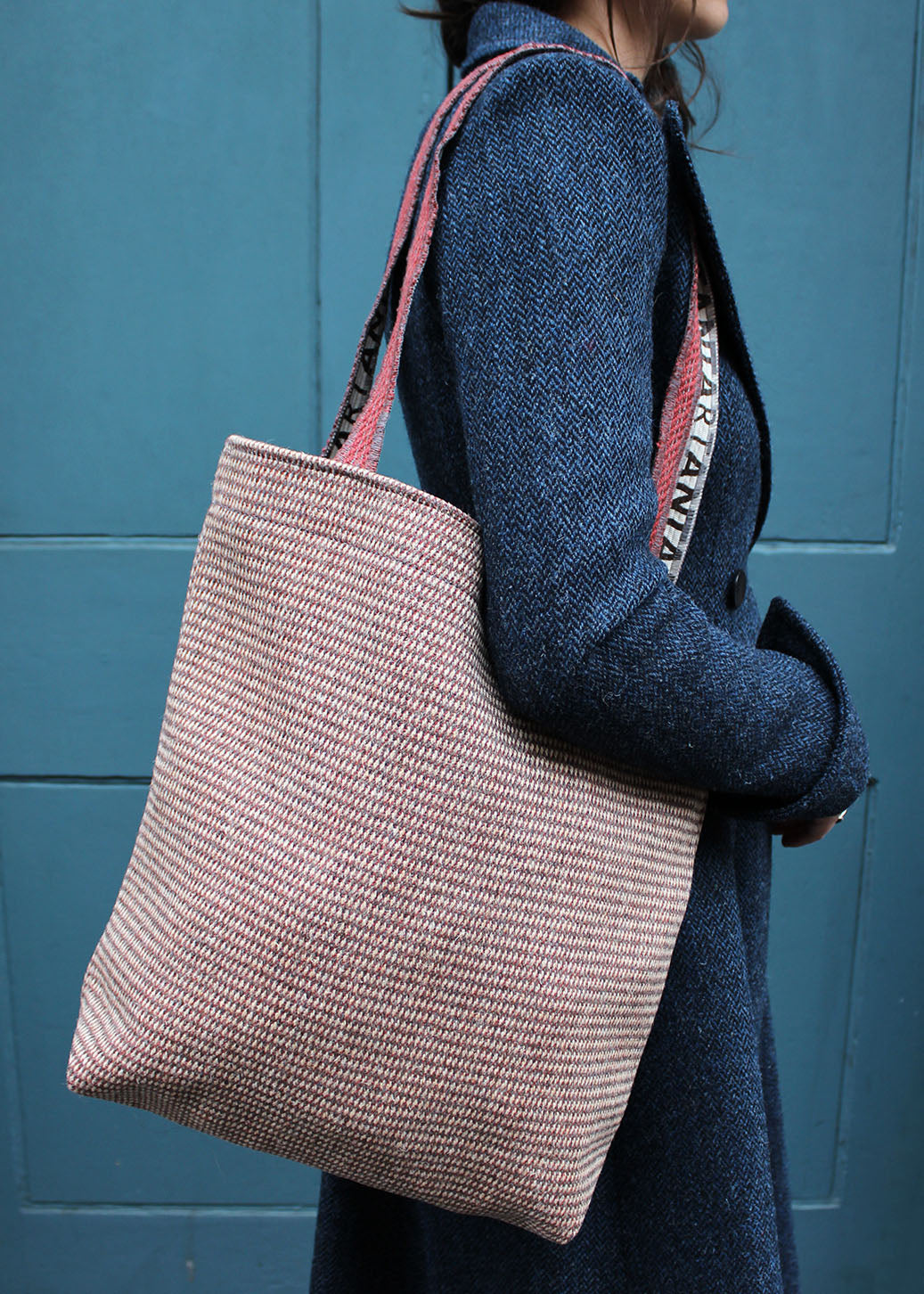 Wool travel bag shown on model. Scottish Textiles Showcase.