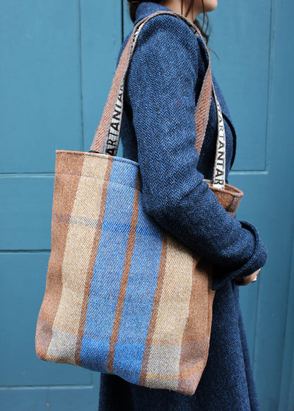 Wool travel bag shown on model. Scottish Textiles Showcase.