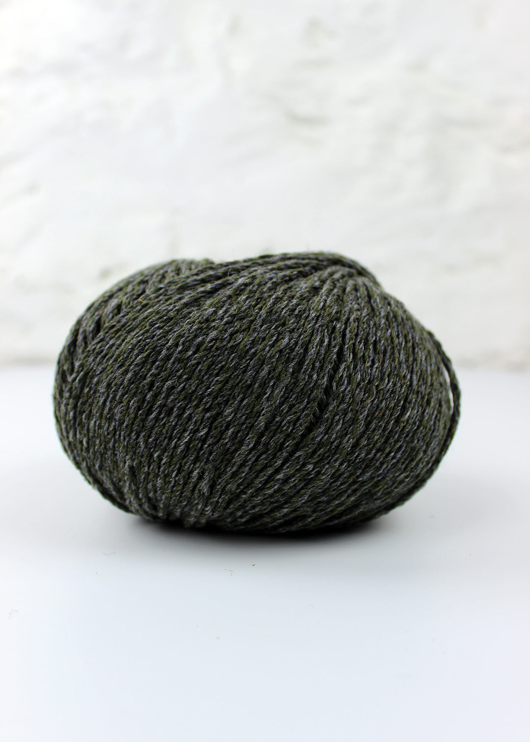 Aran weight pure lambswool yarn in shade Oak which is a subtle blend of khaki green and blue-grey