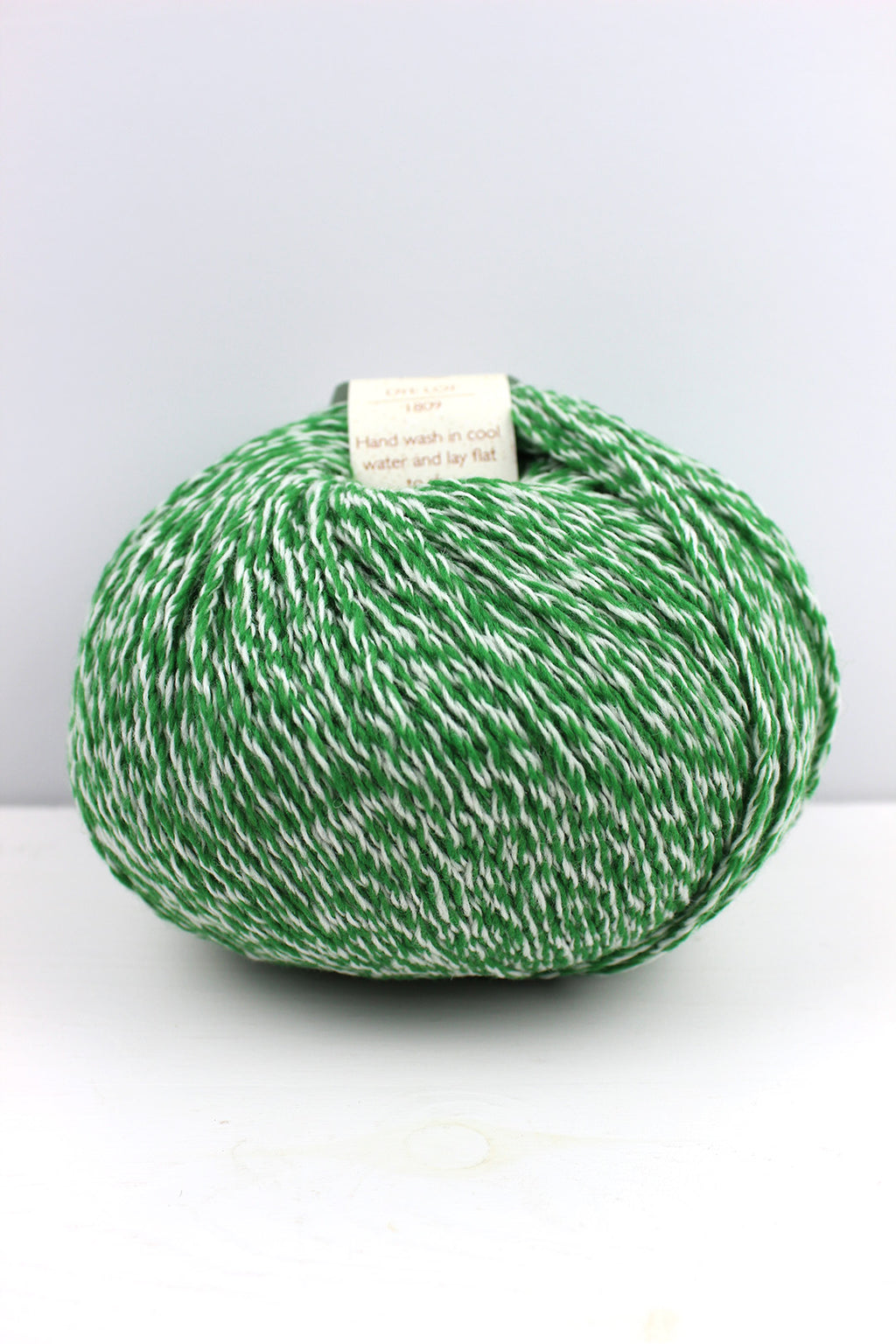 Aran weight wool inspired by the green hues in the leaves of a lovage plant.