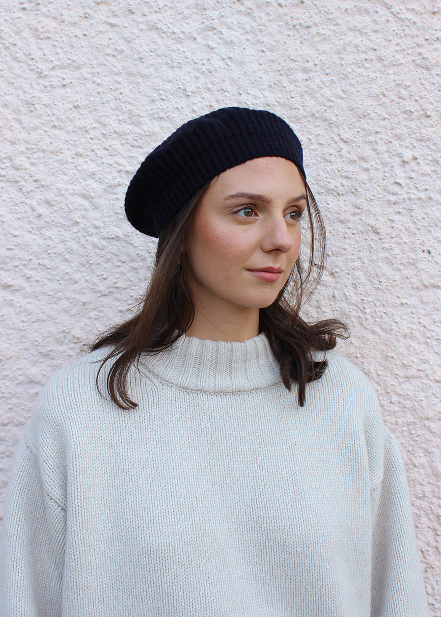 Lambswool navy beret shown on model. Scottish Textiles Showcase.
