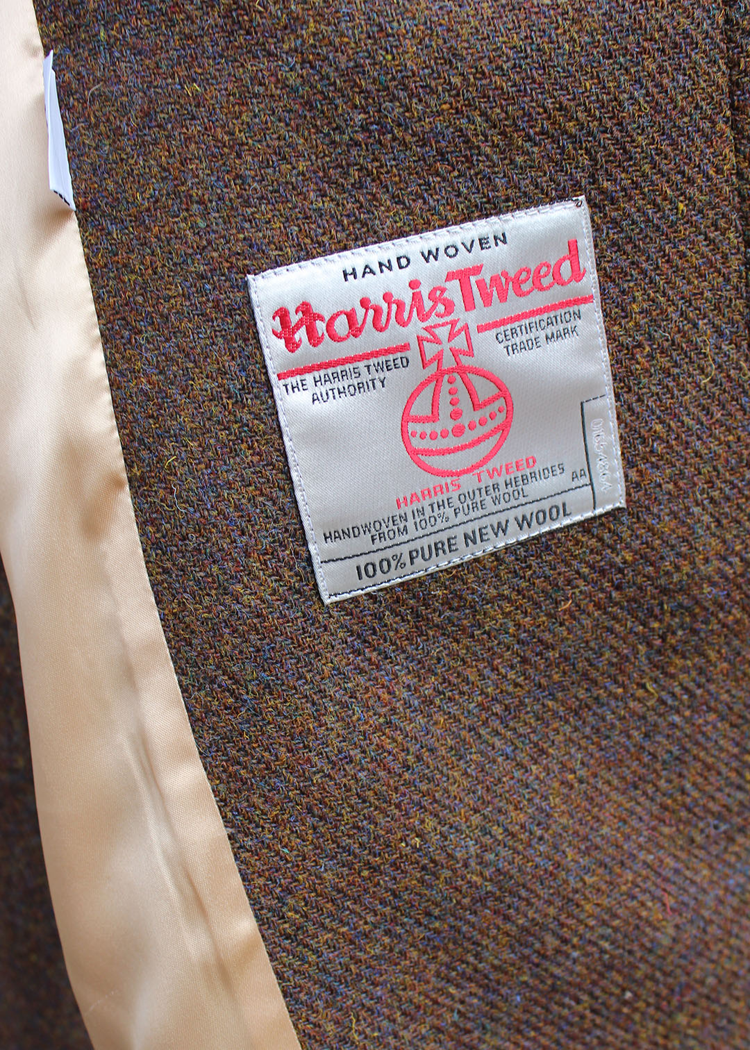 Harris Tweed coat in Ellen style in brown hazel tweed, showing label. Scottish Textiles Showcase.