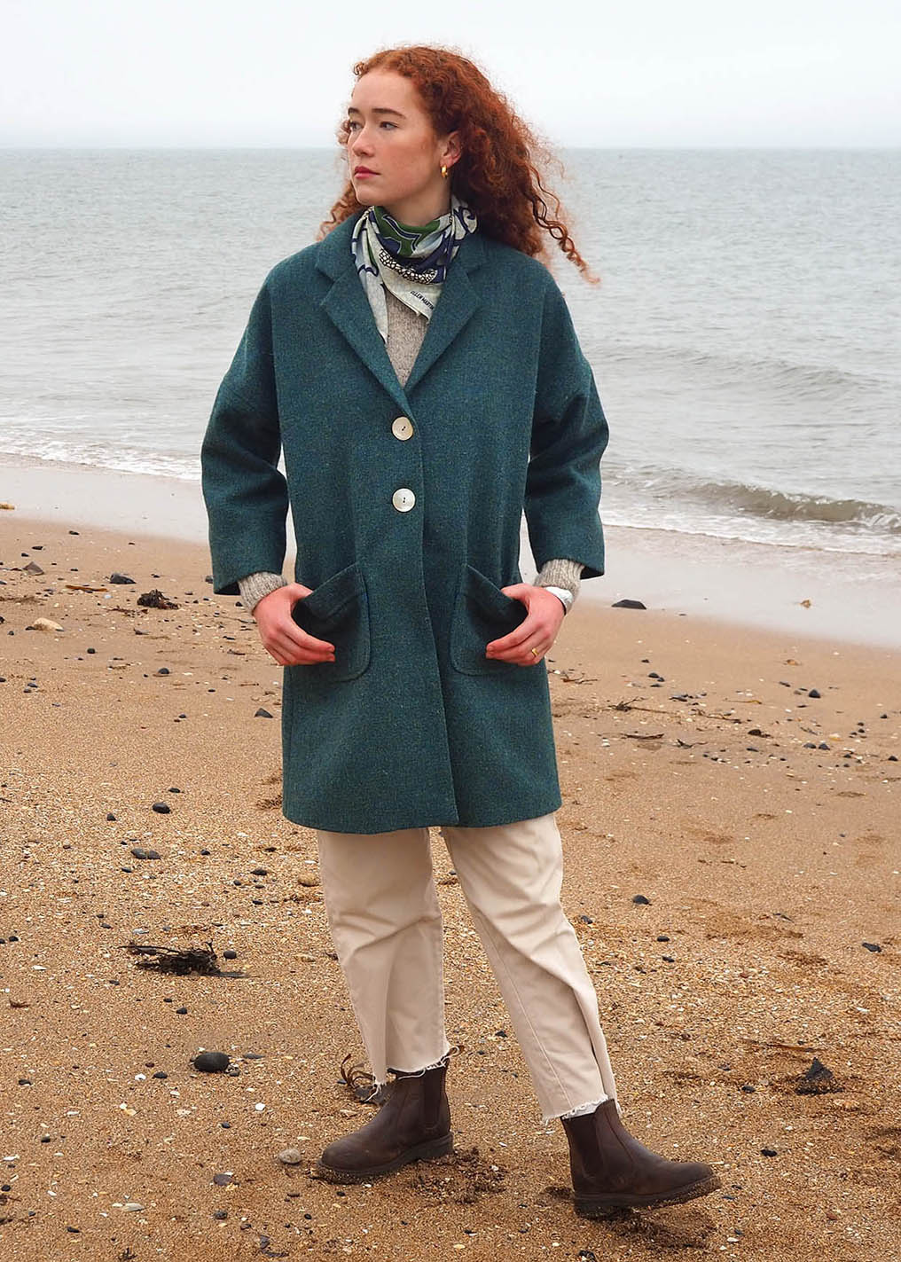 The classic Fiona coat in sea blue is made from hand woven Harris Tweed and features a full satin blue lining. Shown on model.